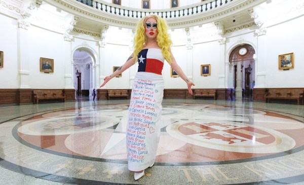 Standing in the rotunda of the Texas State Capitol in Austin, Brigitte Bandit shows the gown she wore—bearing the names of children killed in recent mass shootings in Uvalde and Allen, Texas—to testify against S.B. 12, which would have criminalized drag performances. In her testimony, she accused Texas GOP lawmakers of “spending more time in this legislative session targeting drag queens than gun violence.”