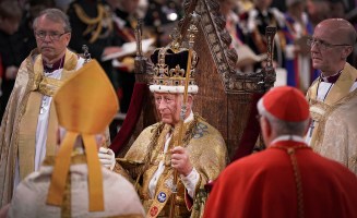 King Charles III sits during his coronation ceremony.