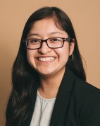 Esperanza Cuautle is a Mexican woman with long black hair and glasses who is smiling at the camera