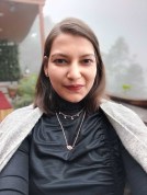 Poorvi Gupta, an Indian woman, looks at a camera