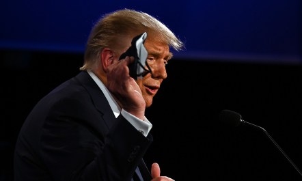 President Donald Trump holding a mask